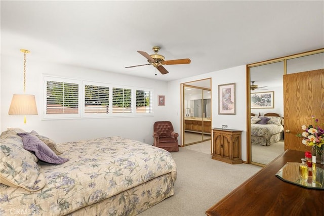 carpeted bedroom with ceiling fan, ensuite bathroom, and a closet