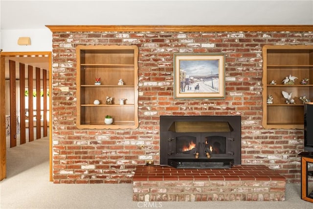 interior details featuring a brick fireplace and carpet flooring