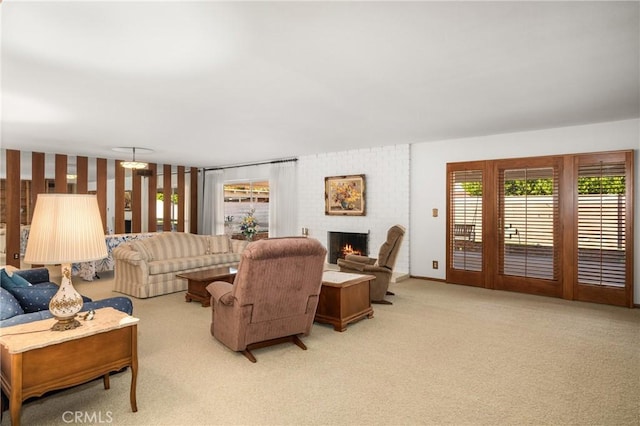 living room with a brick fireplace and light colored carpet