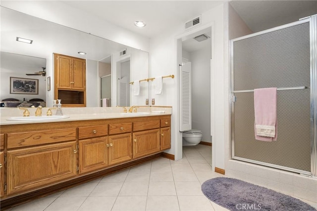 bathroom with vanity, ceiling fan, toilet, and walk in shower