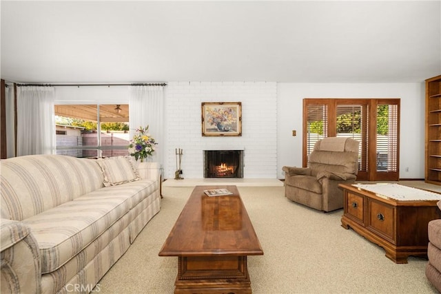 carpeted living room with a brick fireplace