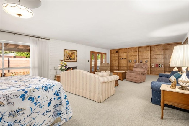 interior space featuring light colored carpet, a fireplace, and multiple windows