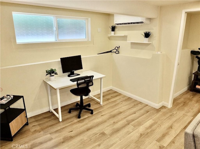 office space with baseboards, an AC wall unit, and wood finished floors