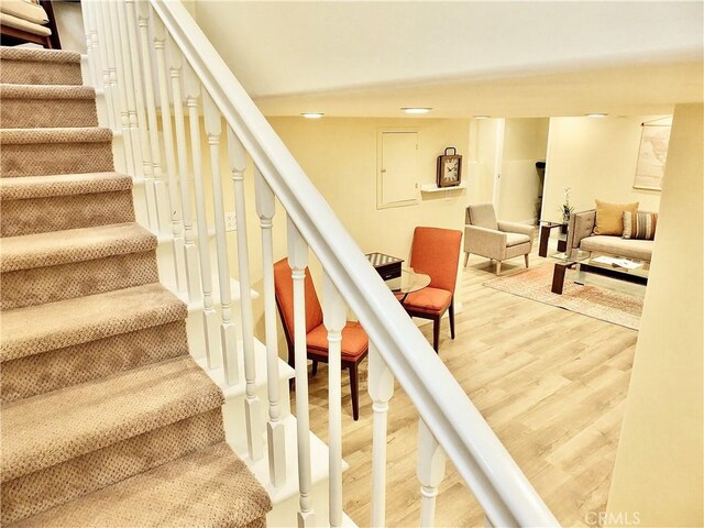 staircase featuring wood finished floors