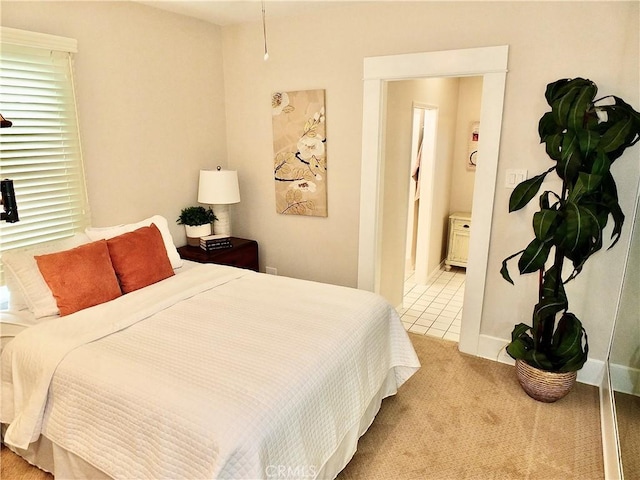 carpeted bedroom with tile patterned flooring and ensuite bathroom