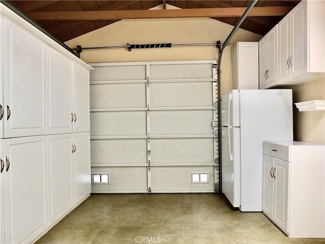 garage with freestanding refrigerator and wood ceiling