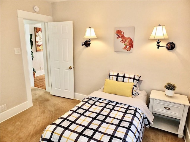 bedroom featuring carpet and baseboards