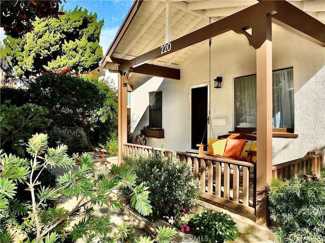 entrance to property featuring stucco siding