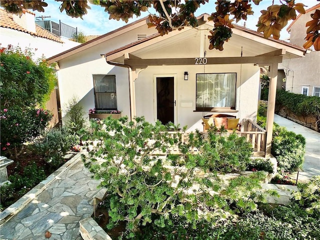 view of front facade featuring a porch and stucco siding