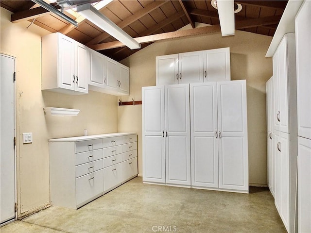 interior space with vaulted ceiling with beams, light countertops, wooden ceiling, and white cabinetry