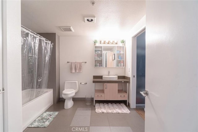 full bathroom with vanity, tile patterned floors, toilet, shower / bath combo with shower curtain, and a textured ceiling