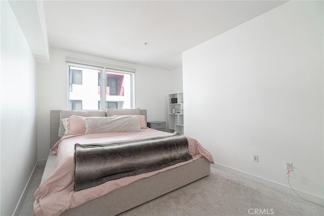 bedroom with light colored carpet