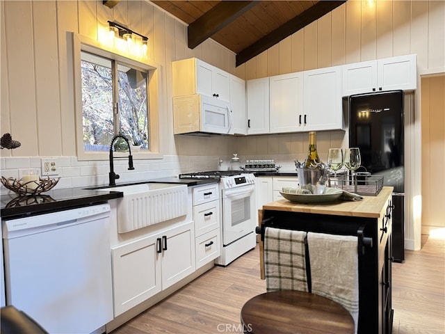 kitchen with white cabinetry, sink, wooden ceiling, vaulted ceiling with beams, and white appliances