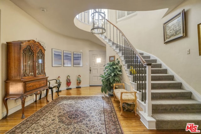 entryway featuring light hardwood / wood-style floors and a high ceiling