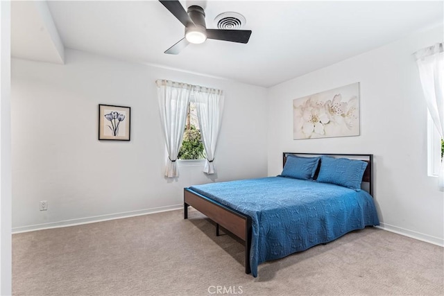 bedroom featuring light carpet and ceiling fan