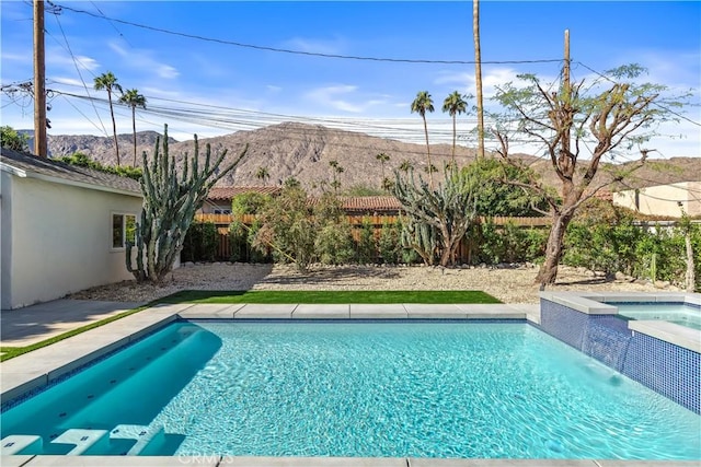 view of swimming pool featuring an in ground hot tub and a mountain view