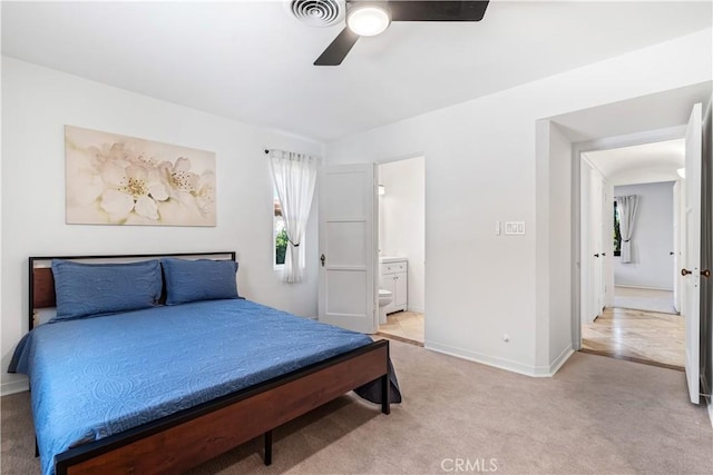 carpeted bedroom featuring connected bathroom and ceiling fan