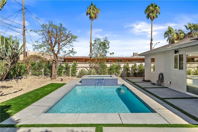 view of pool featuring pool water feature, a patio area, and an in ground hot tub