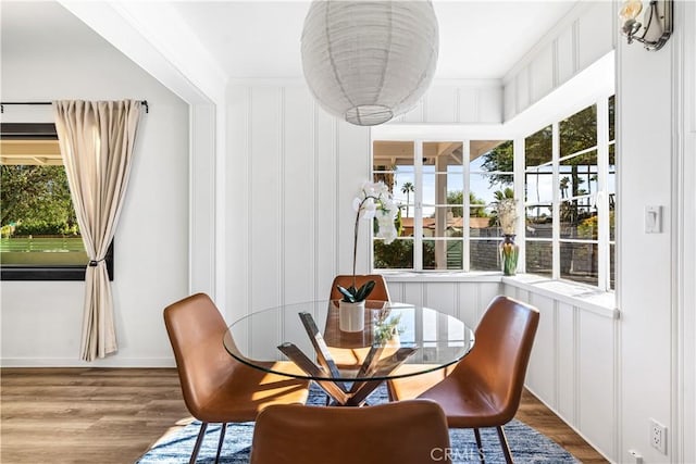 interior space featuring ornamental molding, wood-type flooring, and a healthy amount of sunlight