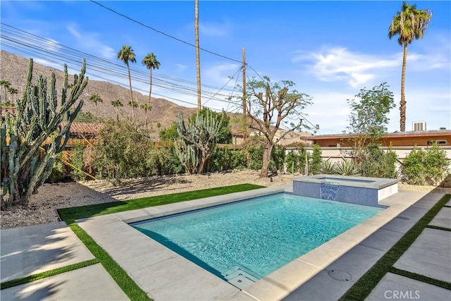 view of swimming pool with a mountain view, an in ground hot tub, and a patio