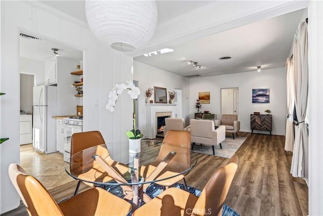 dining space featuring light wood-type flooring and washer / clothes dryer