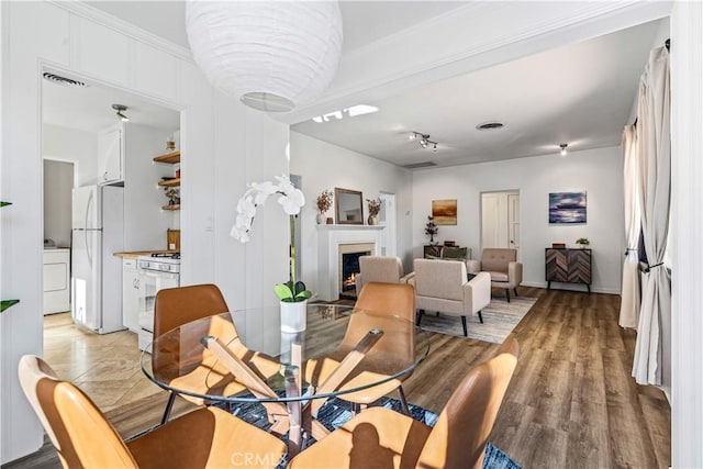 dining area with light wood-type flooring and washer / dryer