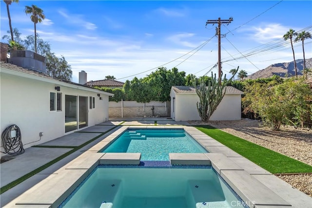 view of swimming pool featuring an in ground hot tub, cooling unit, and a patio