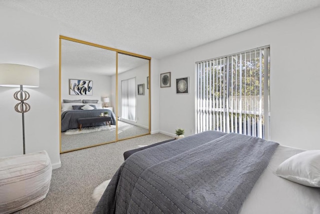 carpeted bedroom with a textured ceiling and a closet