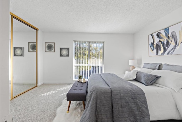 bedroom featuring carpet flooring, a closet, and a textured ceiling