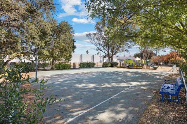 view of sport court with a playground