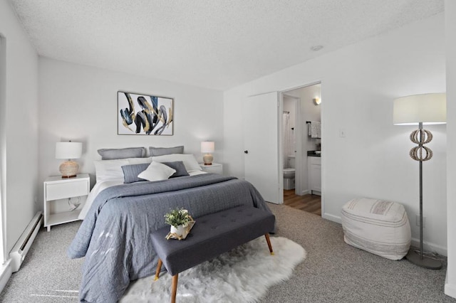 bedroom with carpet, a textured ceiling, ensuite bathroom, and a baseboard heating unit