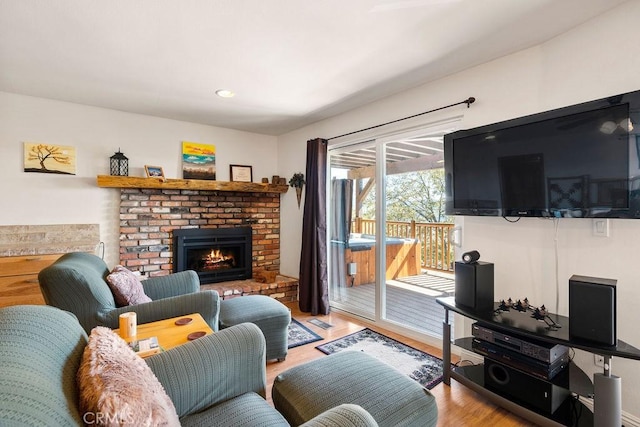 living room with a fireplace and light hardwood / wood-style flooring