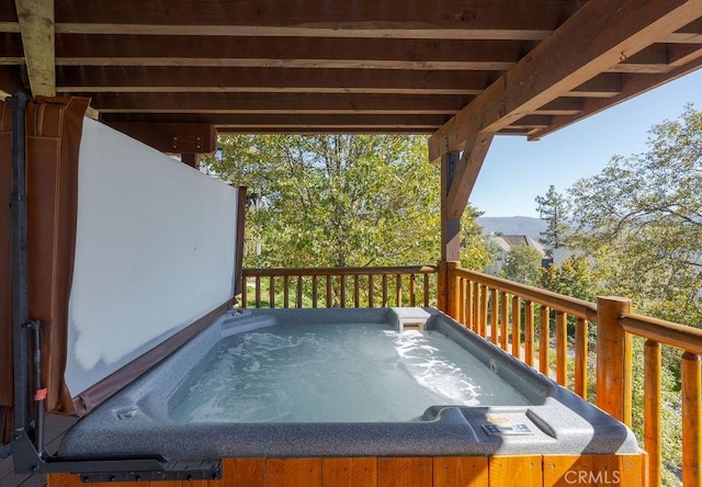 wooden terrace with a hot tub