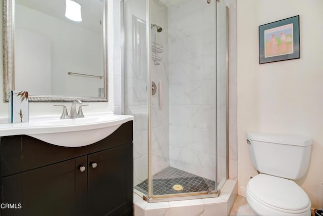 bathroom with vanity, an enclosed shower, and toilet