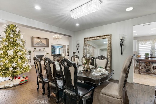 dining area featuring a chandelier and wood-type flooring