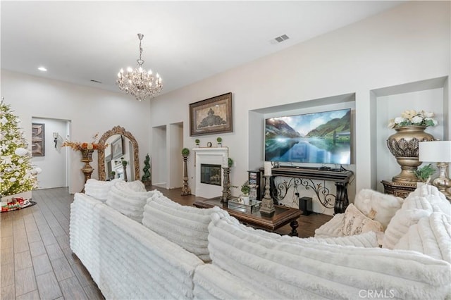 living room featuring hardwood / wood-style flooring and a chandelier