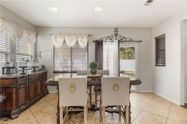 dining space featuring light tile patterned flooring