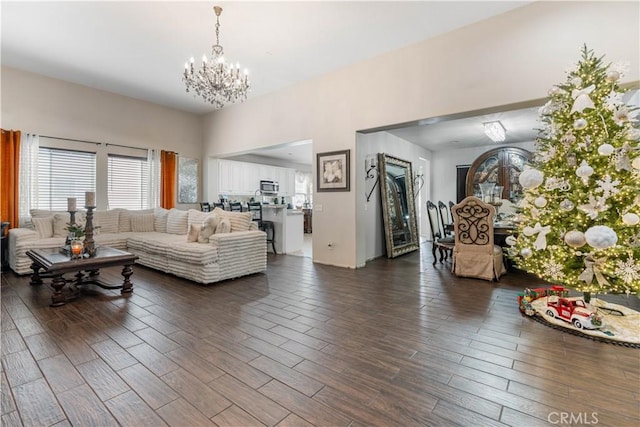 living room with dark hardwood / wood-style flooring and a notable chandelier