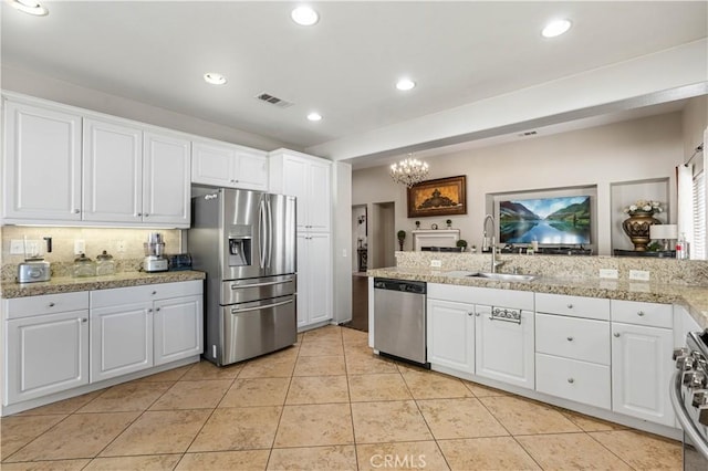 kitchen featuring white cabinets, sink, and appliances with stainless steel finishes