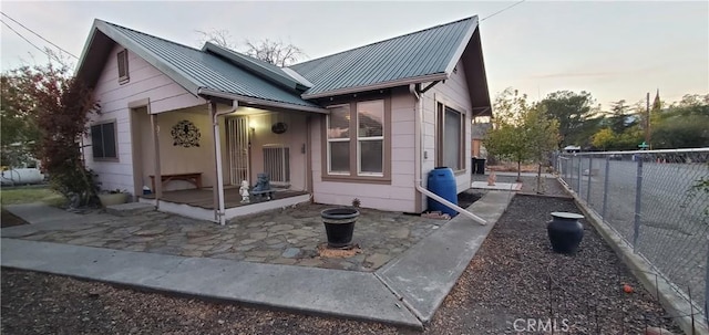 back house at dusk with a patio