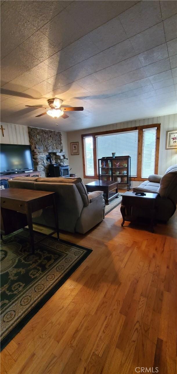 living room featuring ceiling fan and wood-type flooring