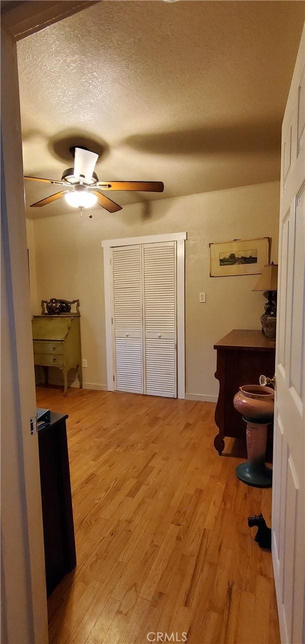 bedroom with a textured ceiling and light hardwood / wood-style flooring