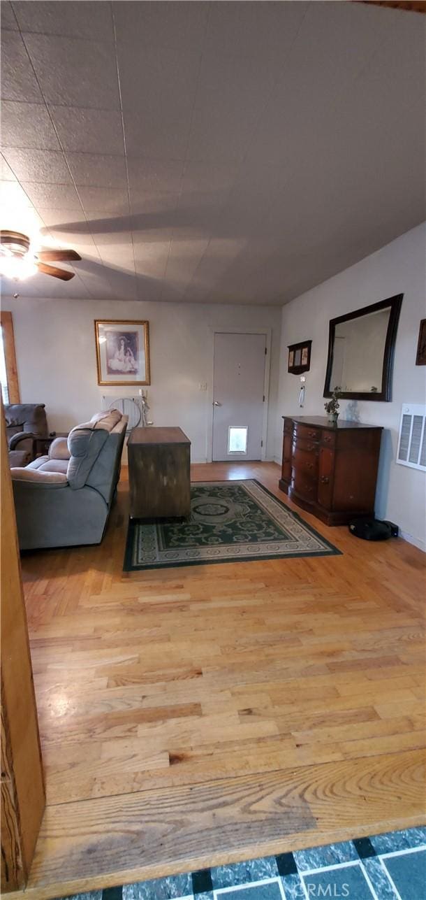 living room with visible vents and wood finished floors