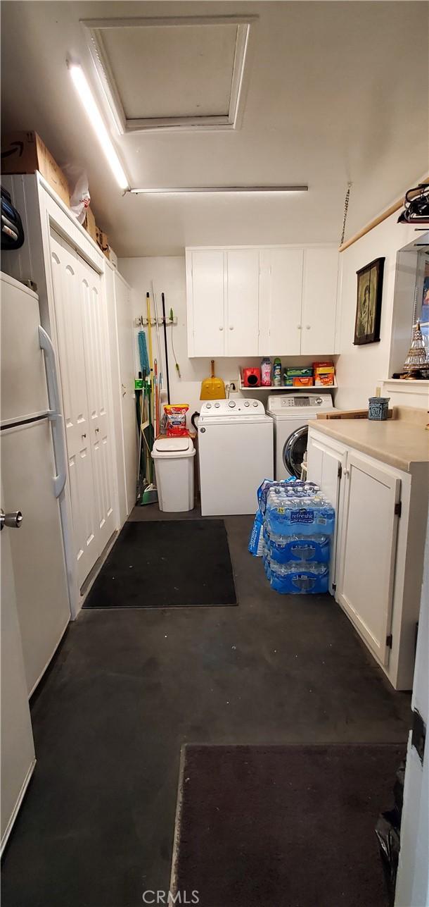 washroom with attic access, cabinet space, and independent washer and dryer