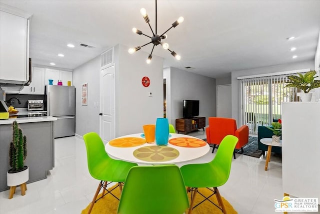 tiled dining area with an inviting chandelier