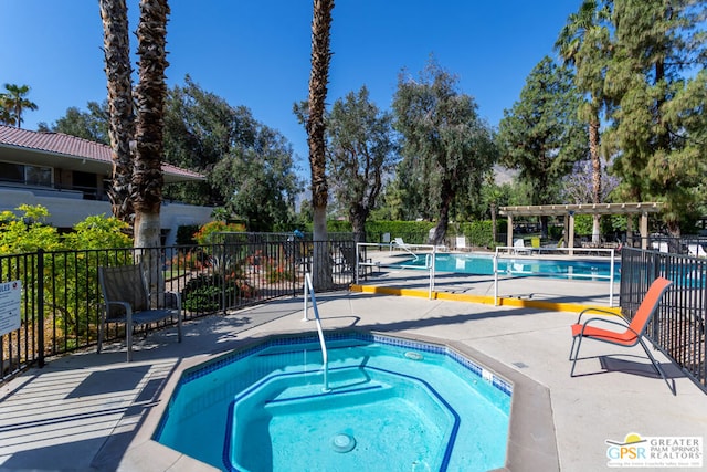 view of pool featuring a community hot tub, a pergola, and a patio