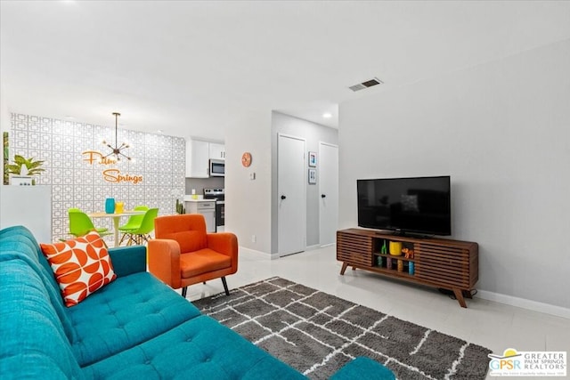 living room with tile patterned floors and a notable chandelier