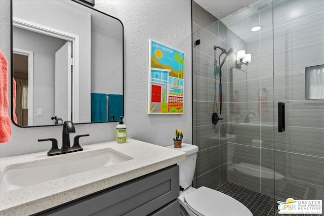 bathroom featuring vanity, toilet, and an enclosed shower