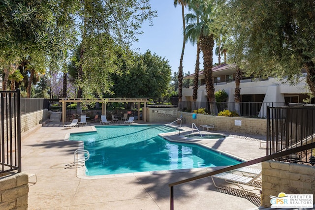 view of pool featuring a patio and a hot tub