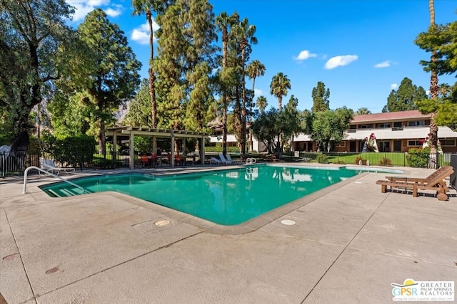 view of pool with a patio and a pergola